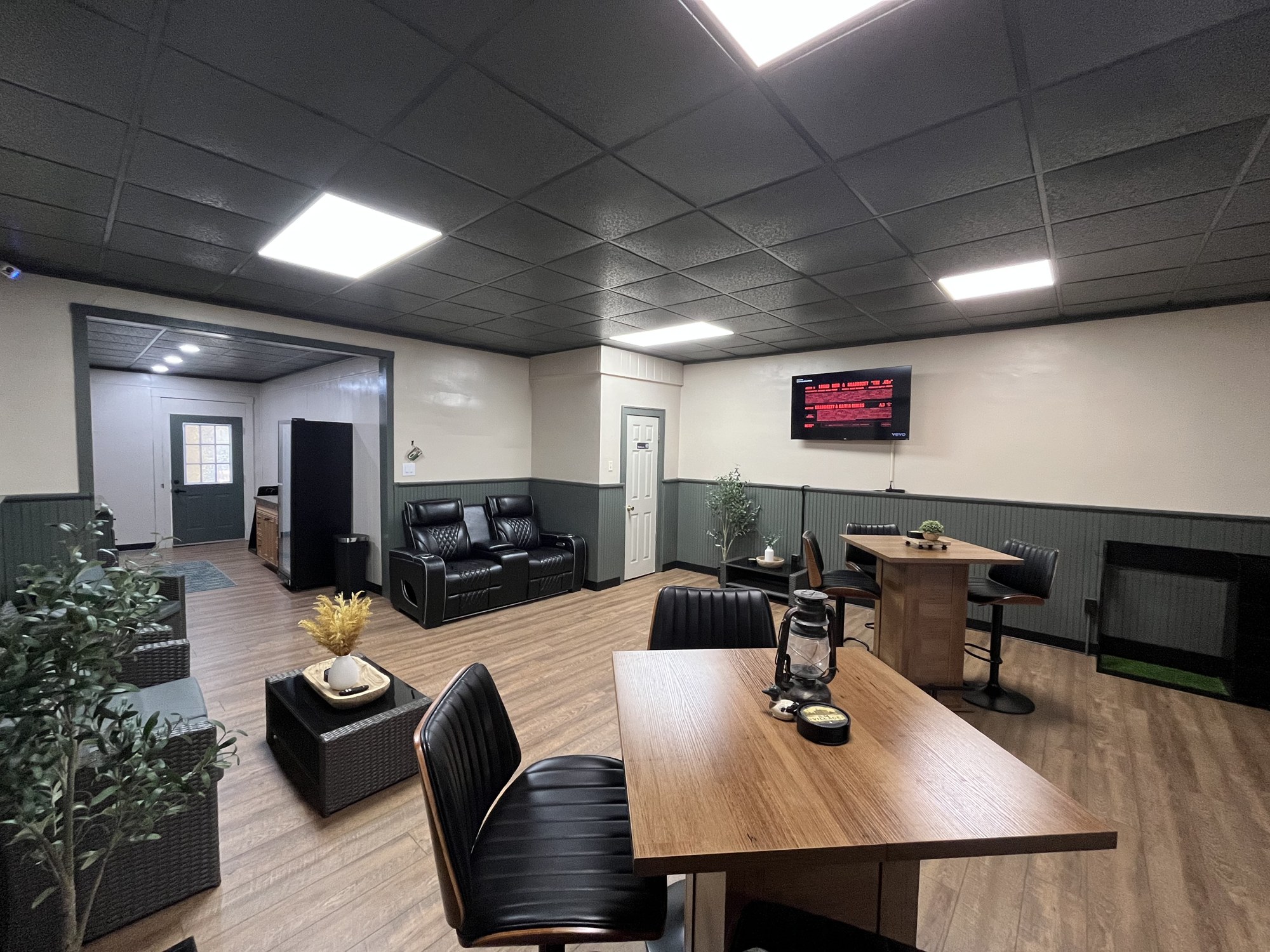 Sim Village lounge with high-top tables and leather seating