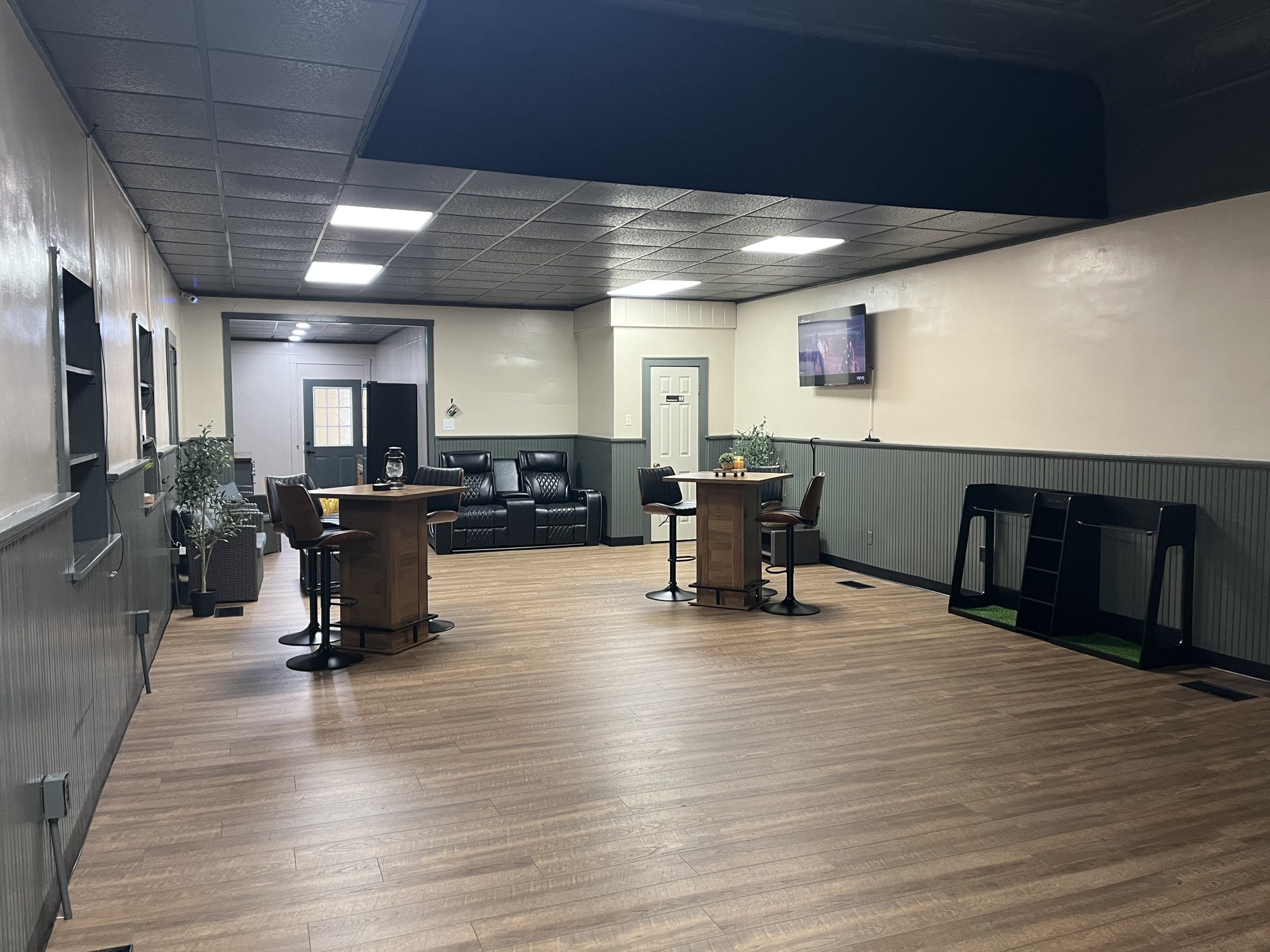 Wide view of the Sim Village lounge with seating and tables