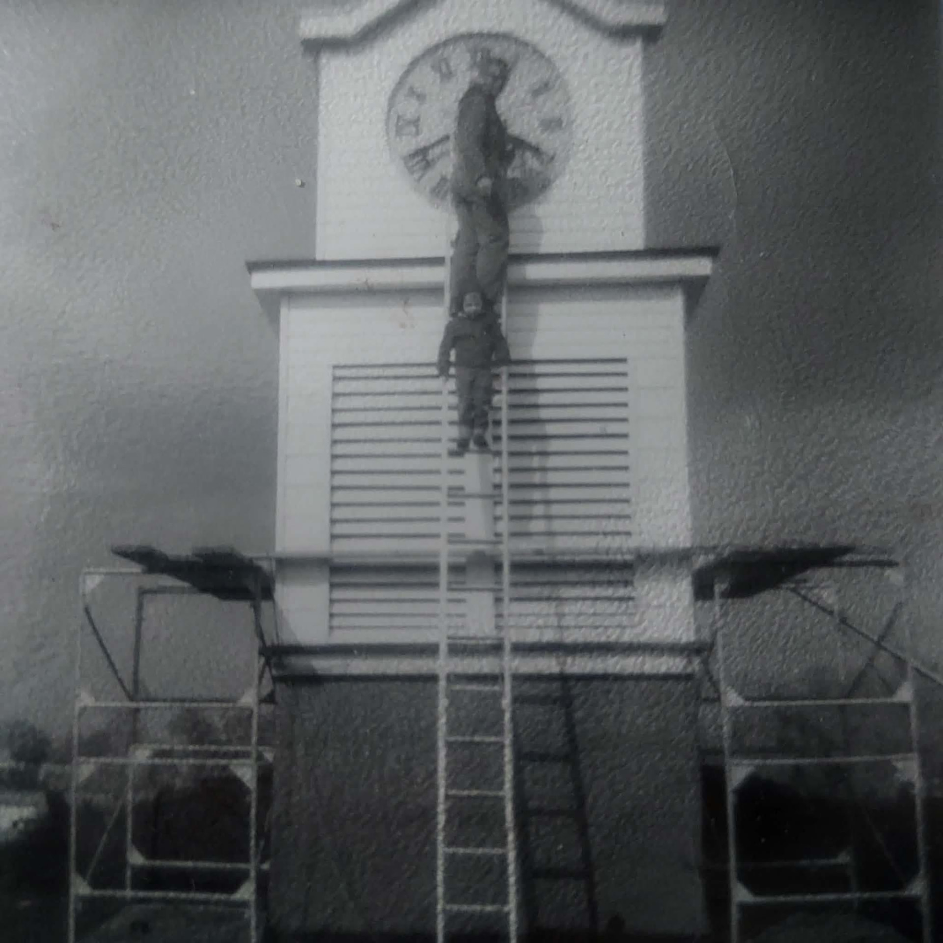 Historic photograph of repair work on the town clock